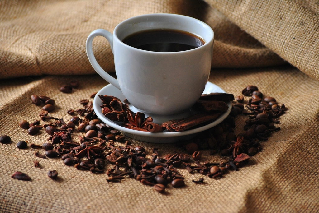 A cup of coffee and roasted beans